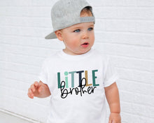 Load image into Gallery viewer, A young child wearing a gray baseball cap and a white t-shirt with the text "Little brother" printed on it.