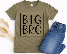 Load image into Gallery viewer, A green t-shirt with the text "BIG BRO" printed on it, along with a pair of blue jeans.