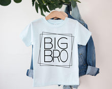 Load image into Gallery viewer, A light blue t-shirt with the text "BIG BRO" printed on it, hanging on a clothing hanger.