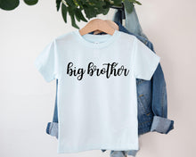 Load image into Gallery viewer, A white t-shirt with the text "big brother" printed on it, hanging on a clothing hanger.