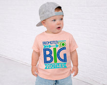 Load image into Gallery viewer, A young child wearing a gray baseball cap and a pink t-shirt with text that says "Promoted to Big Brother".