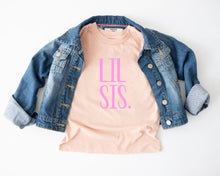 Load image into Gallery viewer, a casual outfit consisting of a denim jacket and a pink t-shirt with the text "LII SIS" printed on it.