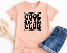 Load image into Gallery viewer, A pink t-shirt with the text "COOL BIG SIS CLUB" printed on it, along with a pair of blue jeans.