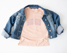 Load image into Gallery viewer, a casual outfit consisting of a denim jacket and a pink t-shirt with the text "BIG SIS" printed on it.