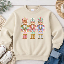 Load image into Gallery viewer, Pastel Nutcrackers Christmas design on Sand crewneck sweatshirt