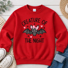 Load image into Gallery viewer, Creature Of The Night Pink Bow Bat Halloween design on Red crewneck sweatshirt
