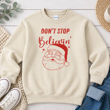 Load image into Gallery viewer, Don't Stop Believin' Santa Christmas design on Sand crewneck sweatshirt
