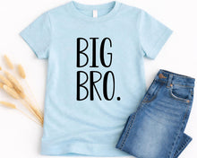 Load image into Gallery viewer, A light blue t-shirt with the text "BIG BRO" printed on it, along with a pair of blue jeans.
