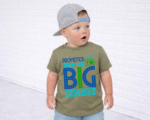 Load image into Gallery viewer, A young child wearing a gray baseball cap and a green t-shirt with a colorful graphic design.
