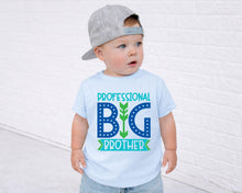 Load image into Gallery viewer, A young child wearing a gray baseball cap and a light blue t-shirt with the text "PROFESSIONAL BIG BROTHER" printed on it.
