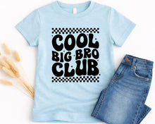Load image into Gallery viewer, A light blue t-shirt with the text "COOL BIG BRO CLUB" printed on it, along with a pair of blue jeans.
