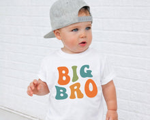Load image into Gallery viewer, A young child wearing a white t-shirt with the text "BIG BRO" printed on it, standing in front of a white brick wall.
