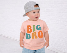 Load image into Gallery viewer, A young child wearing a gray baseball cap and a pink t-shirt with the text "BIG BRO" is standing in front of a white brick wall.
