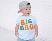 Load image into Gallery viewer, A young child wearing a gray baseball cap and a light blue t-shirt with the text "BIG BRO" printed on it, standing in front of a white brick wall.
