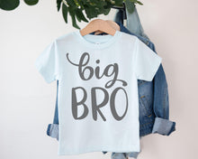 Load image into Gallery viewer, A light blue t-shirt with the text "BIG BRO" printed on it, hanging on a clothing hanger.
