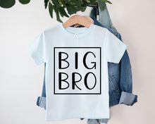 Load image into Gallery viewer, A light blue t-shirt with the text "BIG BRO" printed on it, hanging on a clothing hanger.
