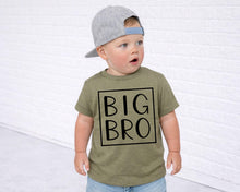 Load image into Gallery viewer, A young child wearing a green t-shirt with the text "BIG BRO" printed on it, standing in front of a white brick wall.
