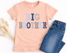 Load image into Gallery viewer, A pink t-shirt with the text "BIG BROTHER" printed on it, along with a pair of blue jeans, are displayed on a white background.
