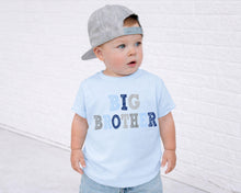 Load image into Gallery viewer, A young child wearing a gray baseball cap and a light blue t-shirt with the text "BIG BROTHER" printed on it, standing in front of a white brick wall.
