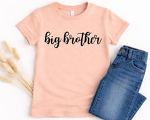 Load image into Gallery viewer, A pink t-shirt with the text "big brother" printed on it, along with a pair of blue jeans, are displayed on a white background.
