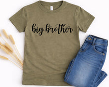 Load image into Gallery viewer, A olive green t-shirt with the text "big brother" printed on it, along with a pair of blue jeans.
