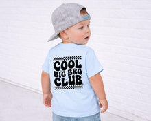 Load image into Gallery viewer, A young child wearing a gray baseball cap and a light blue t-shirt with the text "COOL BIG BRO CLUB" printed on the back.
