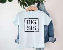 Load image into Gallery viewer, A white t-shirt with the text "BIG SIS" printed on it, hanging on a wooden hanger.
