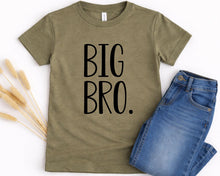 Load image into Gallery viewer, A green t-shirt with the text "BIG BRO" printed on it, along with a pair of blue jeans.
