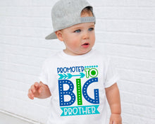 Load image into Gallery viewer, A young child wearing a white t-shirt with a graphic design that says "Promoted to Big Brother" and a gray baseball cap.
