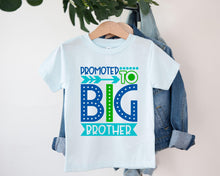 Load image into Gallery viewer, A white t-shirt with a graphic design that says "PROMOTED TO BIG BROTHER" in blue and green text, along with an arrow pointing to the word "BIG".
