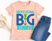 Load image into Gallery viewer, A pink t-shirt with a graphic design that says "PROFESSIONAL BIG BROTHER" in blue and green text, along with a pair of blue jeans.
