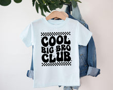Load image into Gallery viewer, A white t-shirt with the text "COOL BIG BRO CLUB" printed on it, hanging on a clothing hanger.
