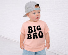 Load image into Gallery viewer, A young child wearing a gray cap and a pink t-shirt with the text "BIG BRO" printed on it, standing in front of a white brick wall.
