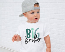 Load image into Gallery viewer, A young child wearing a white t-shirt with the text "BIG brother" printed on it, standing in front of a white brick wall.
