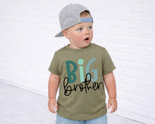 Load image into Gallery viewer, A young child wearing a gray baseball cap and a green t-shirt with the text "BIG brother" printed on it, standing in front of a white brick wall.
