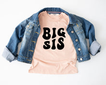 Load image into Gallery viewer, a casual outfit consisting of a denim jacket and a pink t-shirt with the text "BIG SIS" printed on it.
