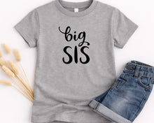 Load image into Gallery viewer, A gray t-shirt with the text "big SIS" printed on it, along with a pair of blue jeans.
