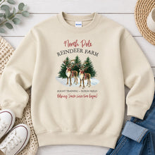 Load image into Gallery viewer, North Pole Reindeer Farm Christmas design on Sand crewneck sweatshirt
