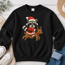 Load image into Gallery viewer, Raccoon Riding Reindeer Christmas design on Black crewneck sweatshirt
